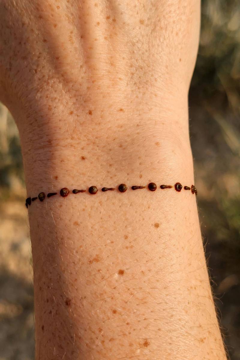 Dot and dash bracelet mehndi design around the wrist
