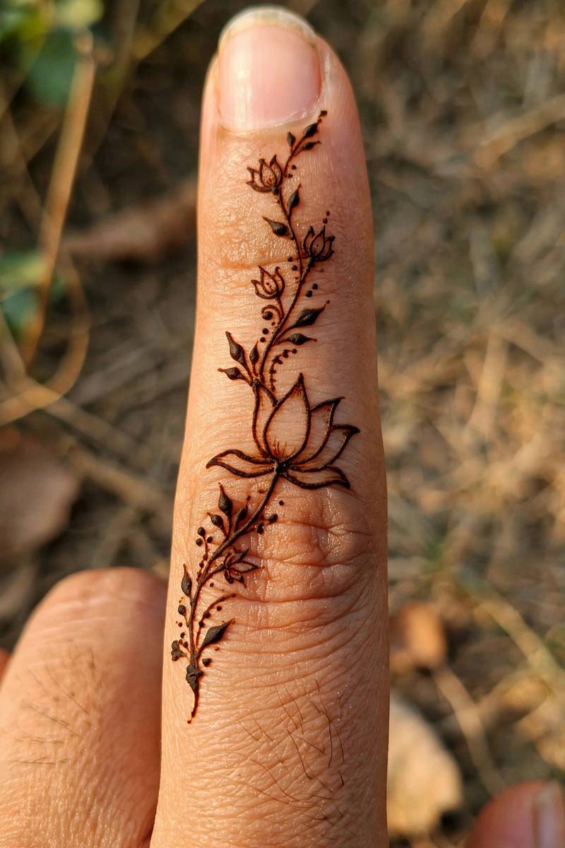 Simple half lotus mehndi design on a finger